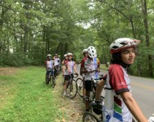 youth cyclists stopped at side of road resting